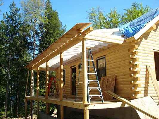 Construction of the porch on a log home from Big Twig.