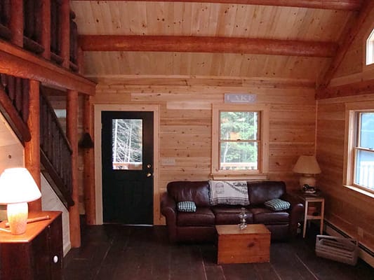 The living room in a cozy log cabin from Big Twig Homes.