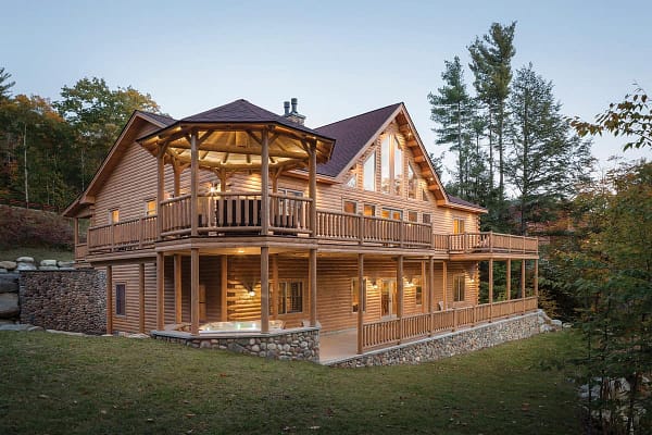 Exterior multi level with a wrap around deck custom log home