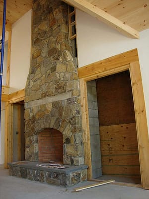 A handcrafted stone fireplace.