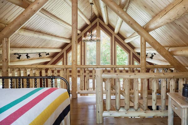 Open wooden loft area with beds