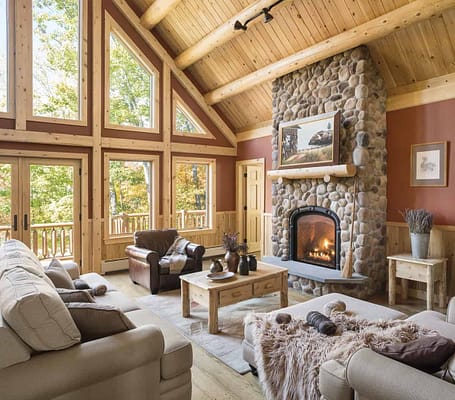 Living room with vaulted ceilings and a stone fireplace