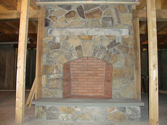 A beautiful stone fireplace in a home built by Big Twig Homes.